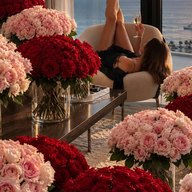 A room filled with red and blush roses at sunset